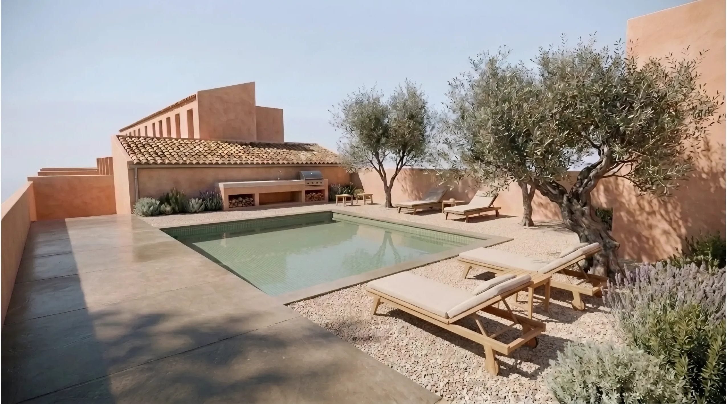 Piscina comunitària amb gresite verd, plataforma de grava, oliveres madures i cuina exterior de formigó amb llenyer.